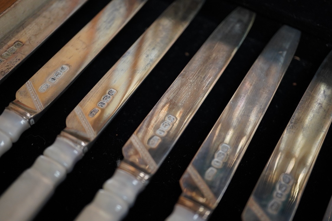 A set of twelve pairs of George V mother of pearl handled silver dessert eaters, by Roberts & Belk, Sheffield, 1926, knife 19.3cm, in a fitted oak box.